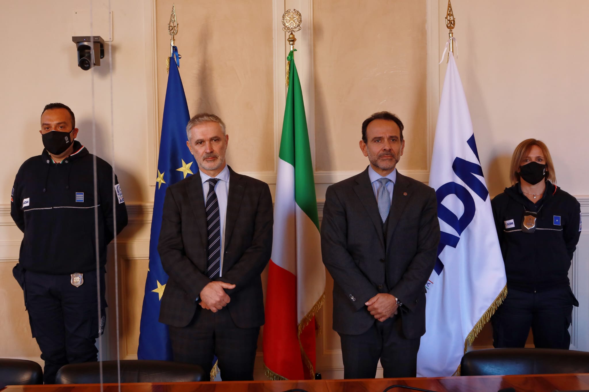 two men and two police men with the Italian flag, European flag