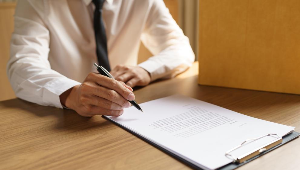 a man signing a document