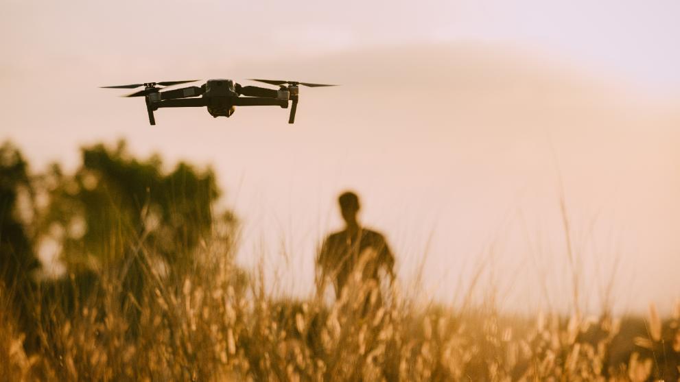 drones flying over field