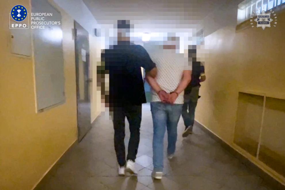 Arrested suspect in Poland with logos