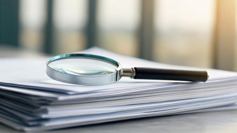 Documents under magnifying glass