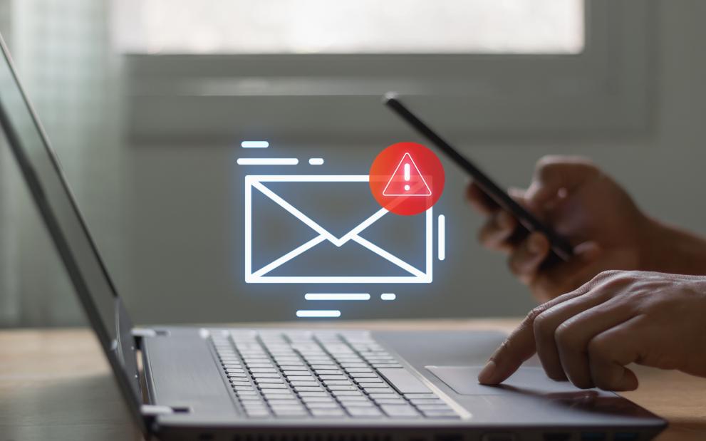 Image portrays a laptop and an emergency hollogram