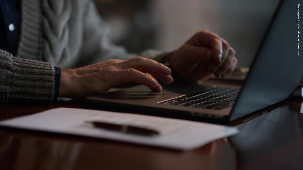 Elder typing on computer