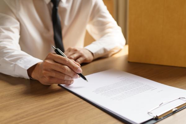 a man signing a document
