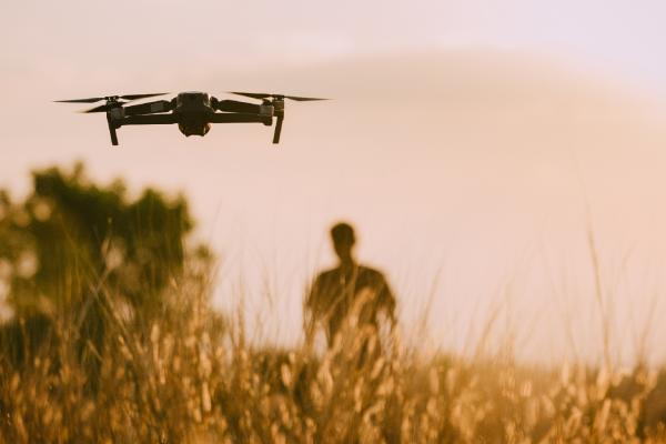 drones flying over field
