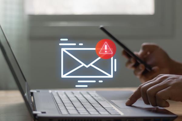 Image portrays a laptop and an emergency hollogram