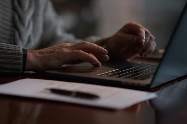 Elder typing on computer